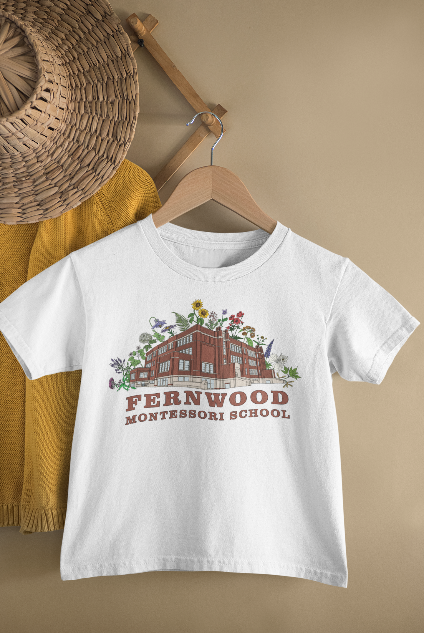 mockup-of-a-kid-s-t-shirt-hanging-from-a-wall-rack-33736 (1).png