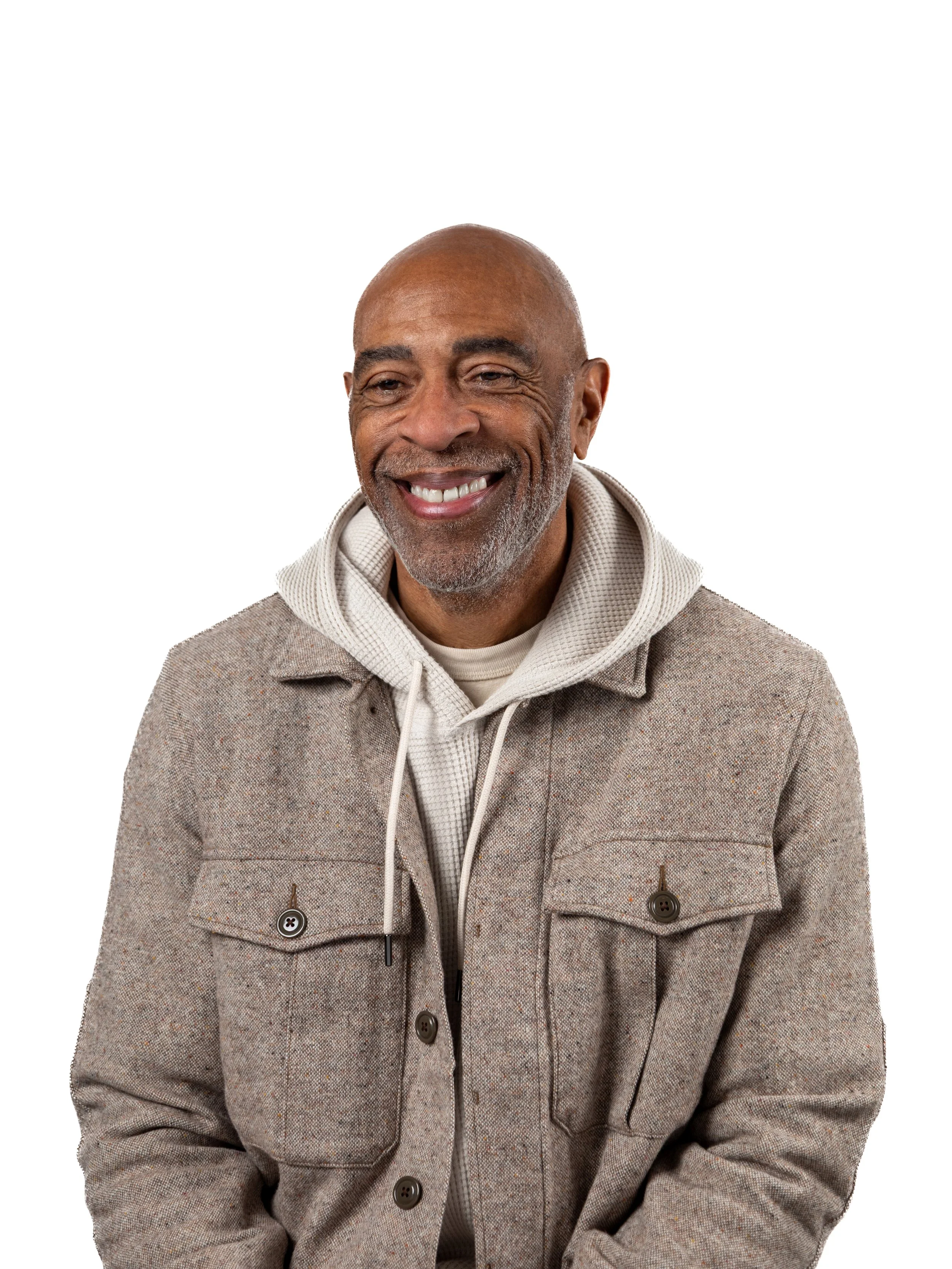 Full body portrait of chief executiv officer Danny Robinson posing at the Dale Chihuly Red Reeds glass exhibit and pond at the Virginia Museum of Fine Arts in Richmond, Virginia on a bright and sunny day, wearing navy jacket and patterned blue slacks