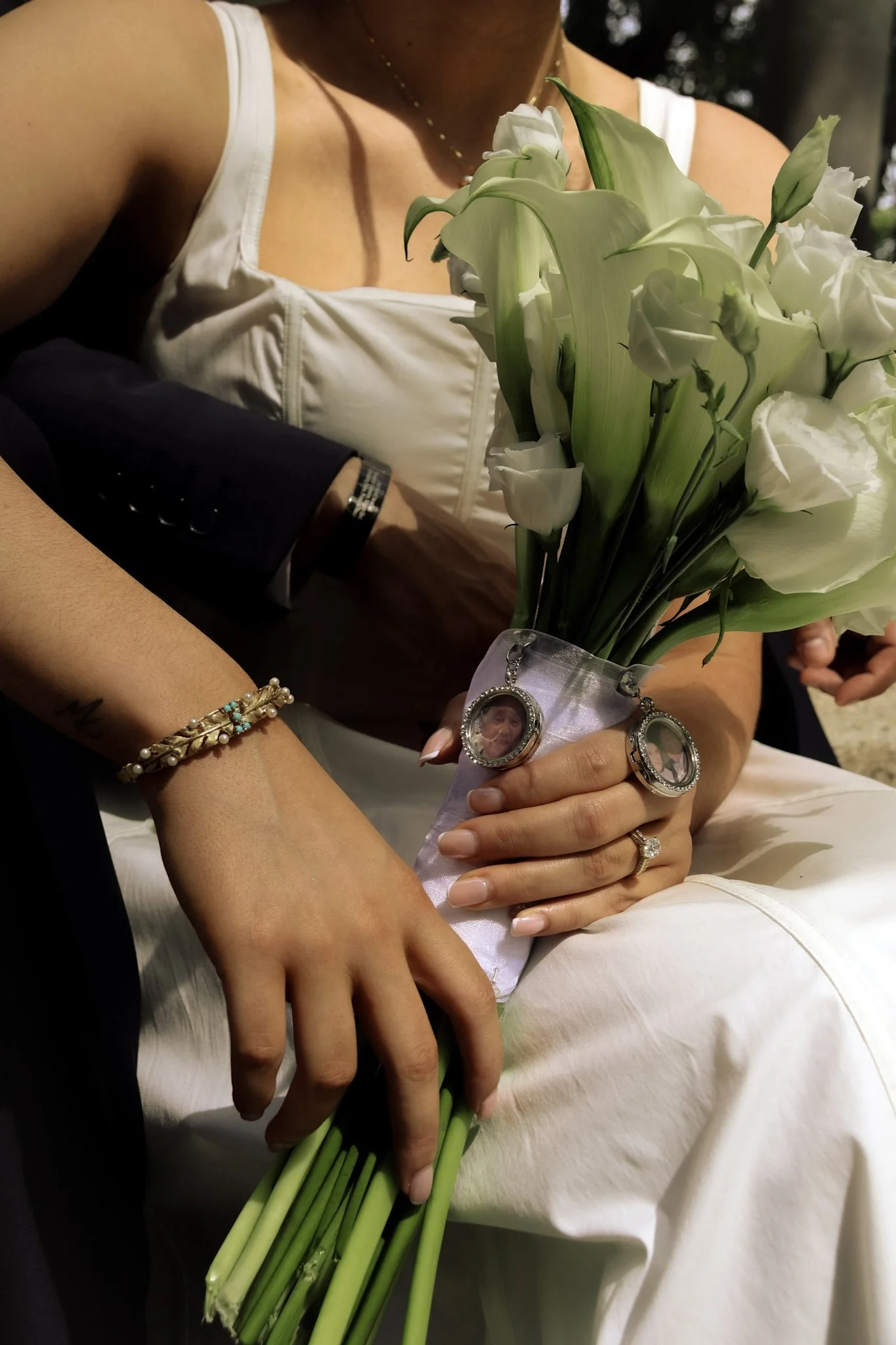 A quiet, intimate moment of hands carefully arranging white flowers, highlighting texture, movement, and natural light