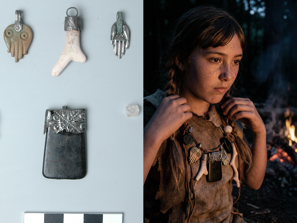 Left side: various ancient or tribal metallic pendants and objects, including an owl, foot, hand, and a rectangular object with detailed metalwork. Right side: young girl with braided hair wearing a necklace with similar pendants, sitting outdoors near a campfire at dusk.