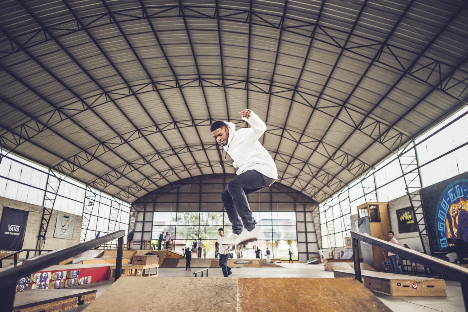 A young skater mid-air over a ramp at the La Roca skate park.