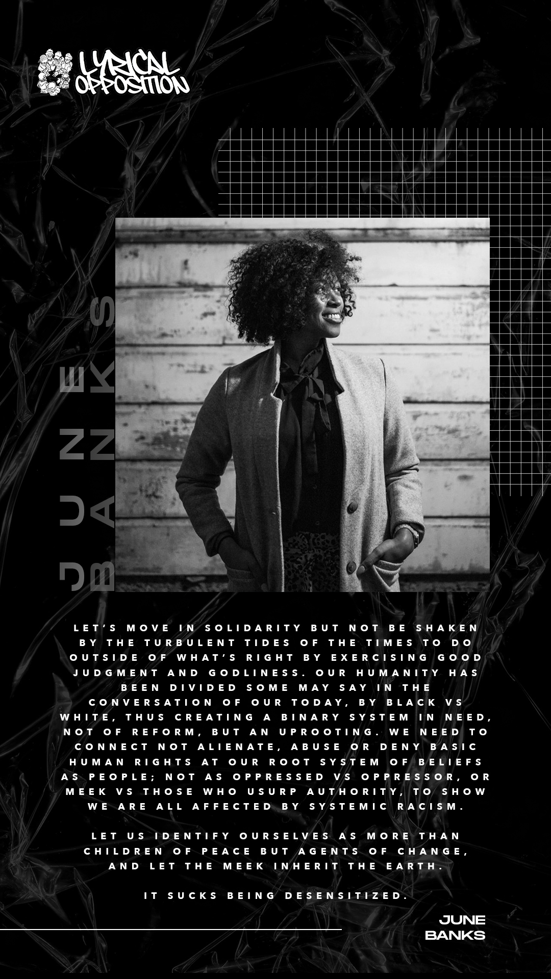 Black and white photograph of a smiling woman with curly hair, wearing a coat and standing outdoors in front of a wooden wall.