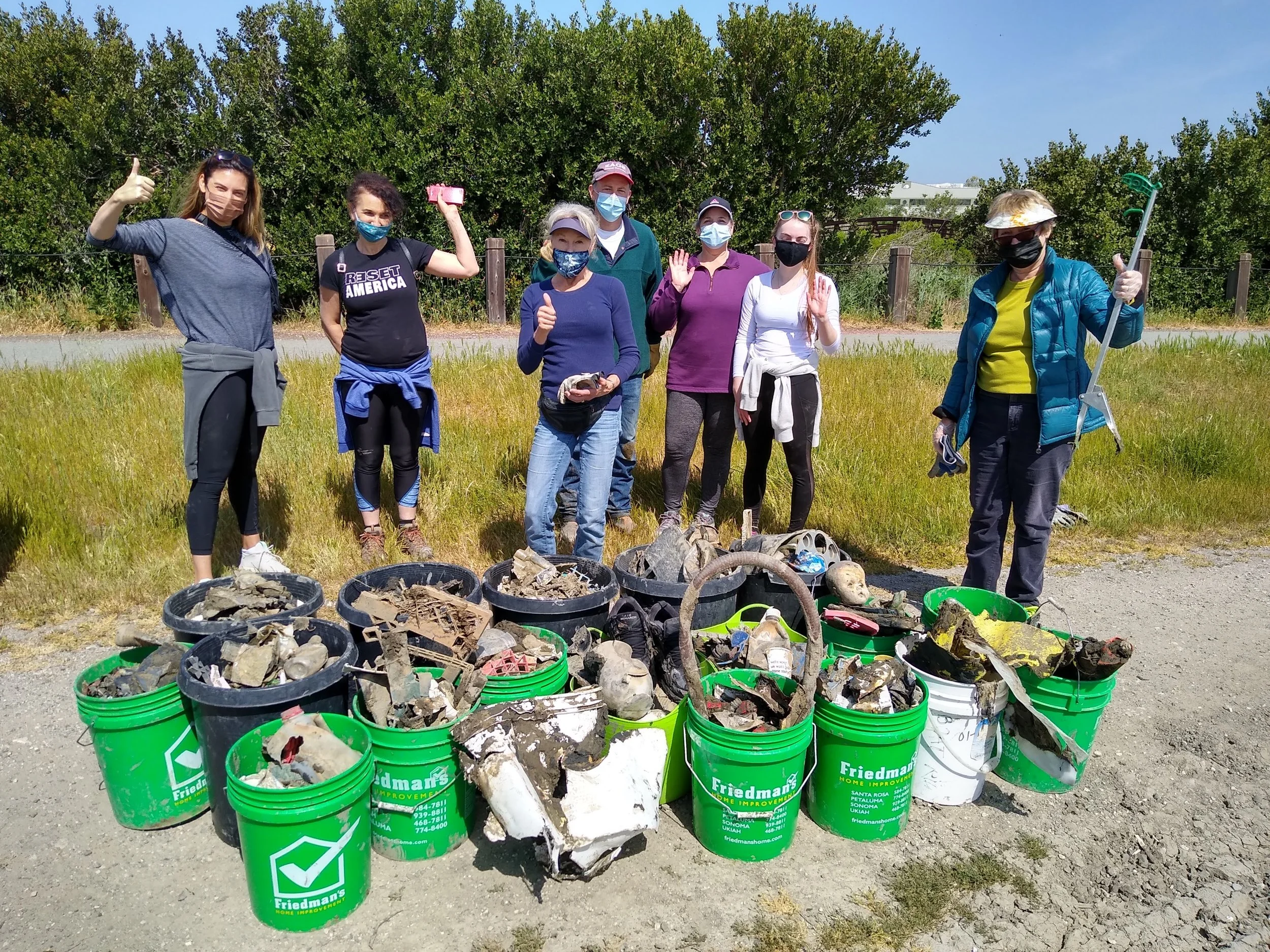 One of 14 volunteer groups clean up Shollenberger Park Central Pond after dredging.