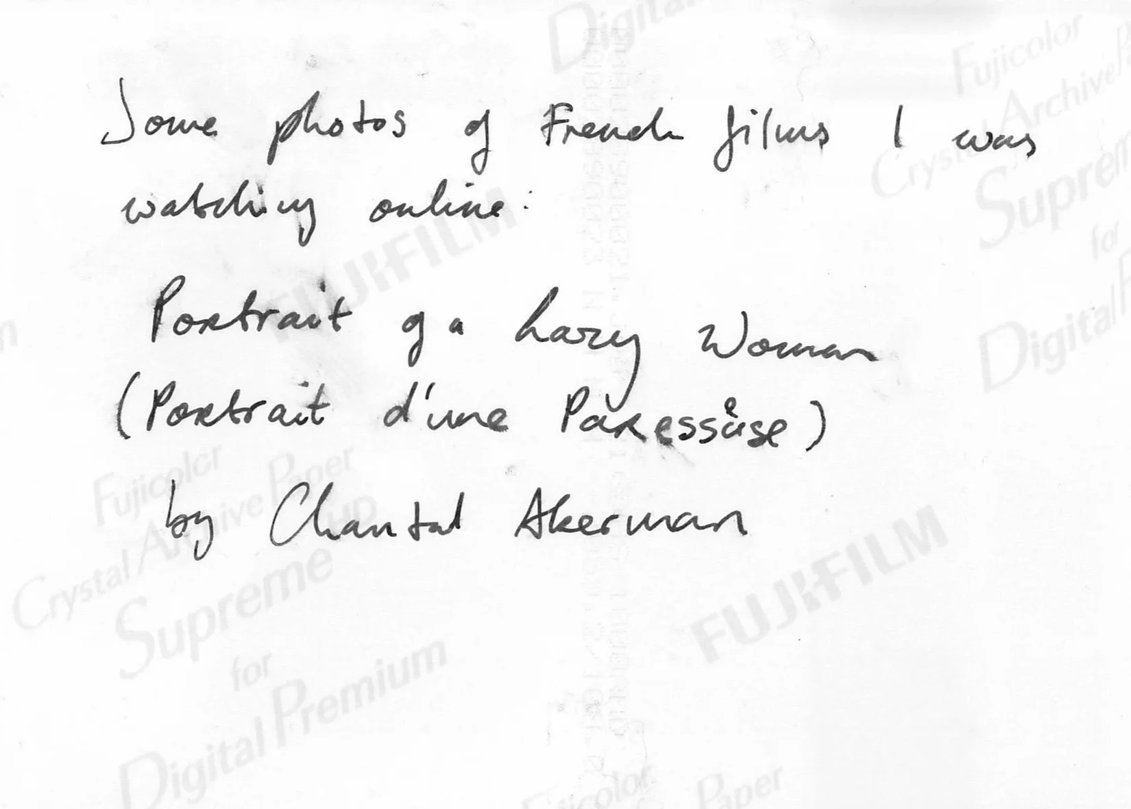 The reverse side of the photo, a handwritten note, says: Some photos of French films I was watching online: Portrait of a Lazy Woman (Portrait d’une Paresseuse) by Chantal Akerman.
