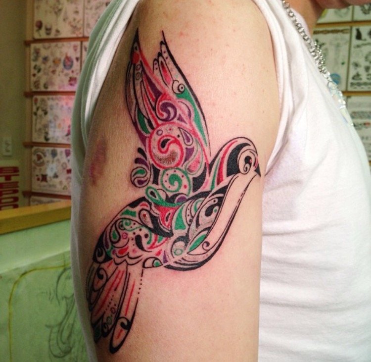 Memorial tattoo of a bird including a date and the