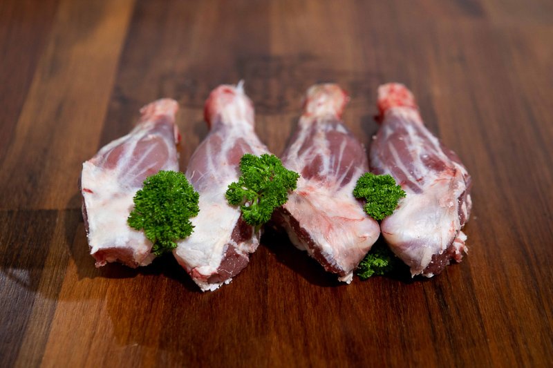 Lamb shanks on a wooden chopping board
