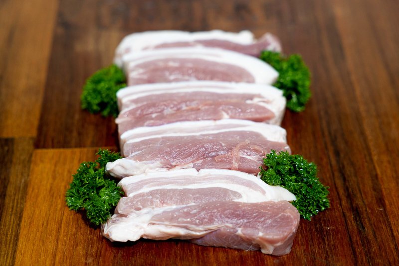 Pork pieces on a wooden chopping board