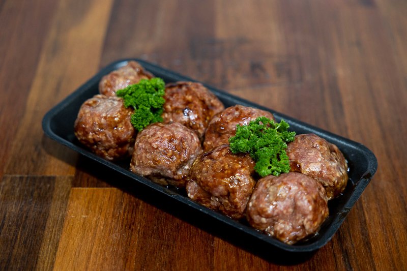 marinated rissoles on a wooden chopping board