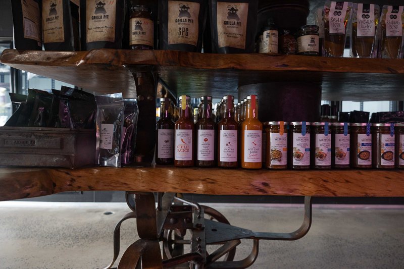 Condiment display shelf. Visible are Beerenberg brand sauce and marinade varieties. 