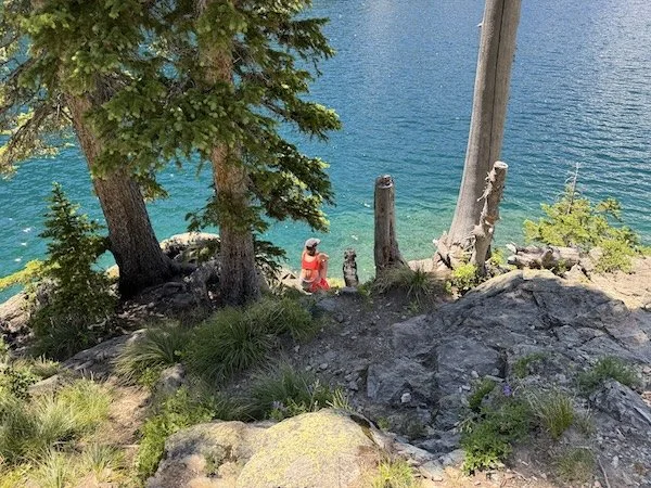 turquoise colored lake, Cheyenne and Cole the lab dog sitting beside