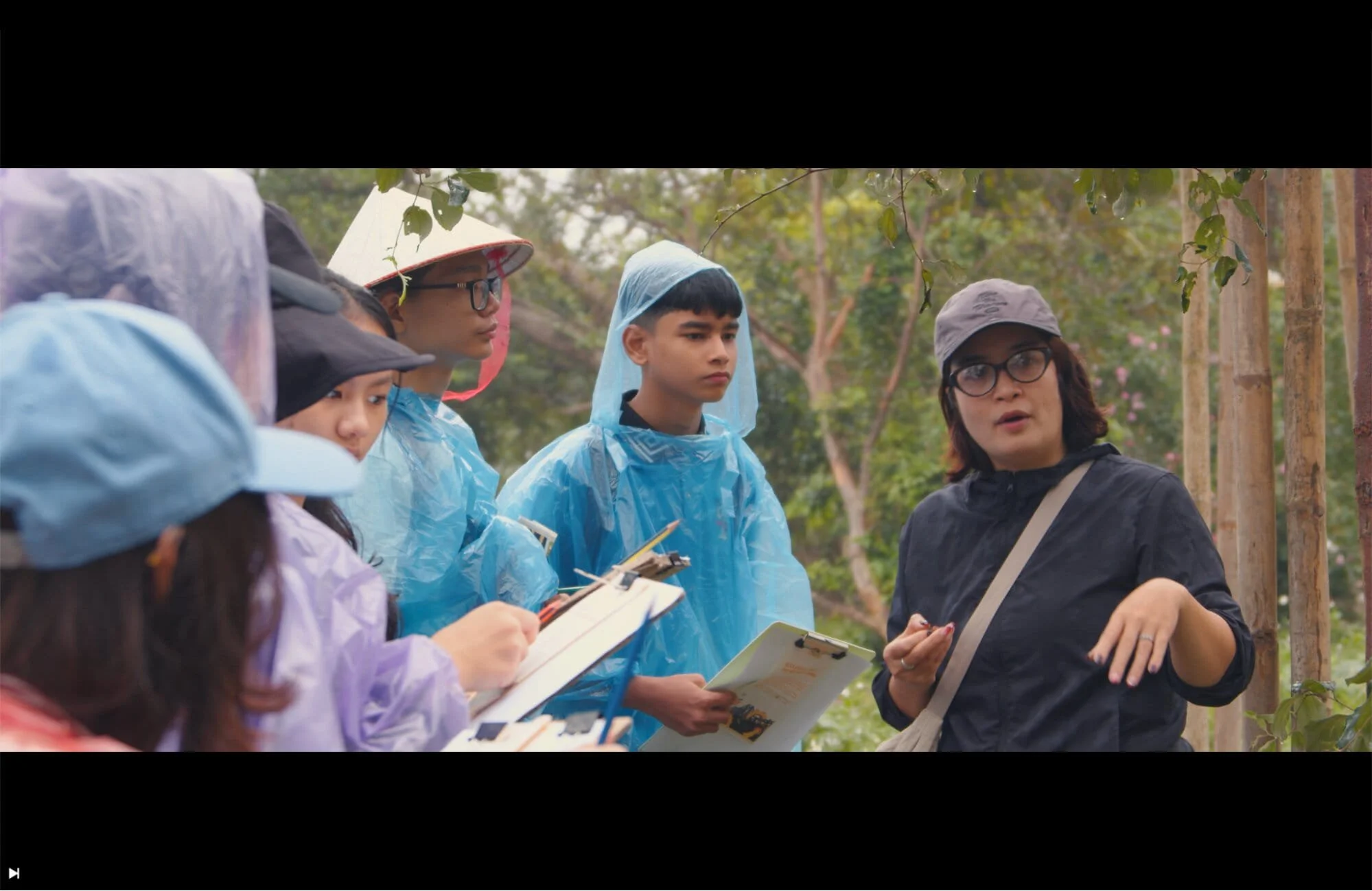 Students taking notes and observing local environments during an educational trip in Vietnam.