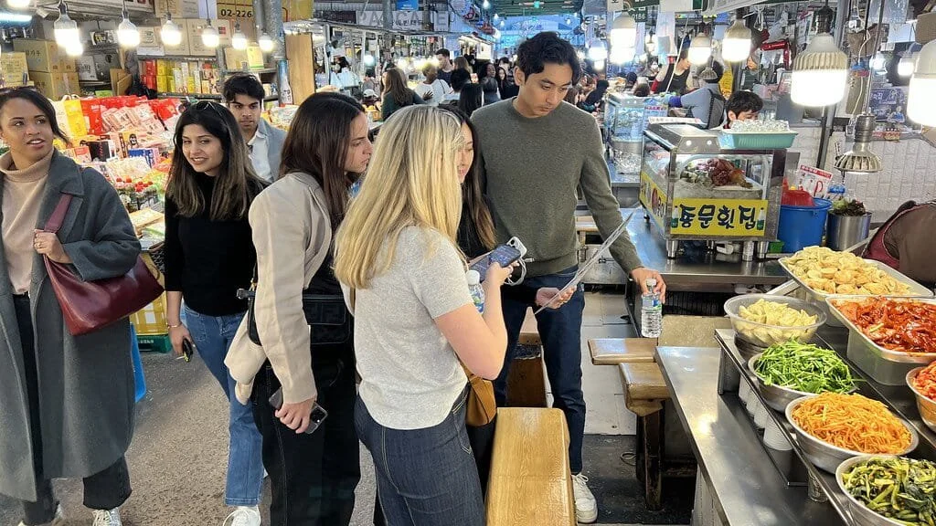Students observing contrasts between traditional and modern areas in South Korea.
