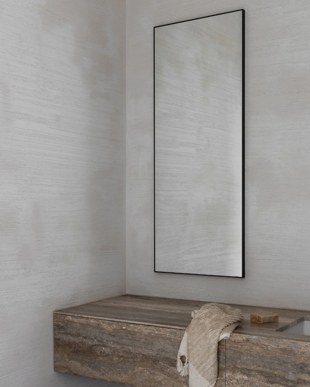 The bathroom at Barwon Heads House hero&rsquo;s a custom hand-raked wall finish that we developed for this project. This bespoke texture was created as a material translation of the coastal vernacular here. It introduces subtle desaturation, quiet gr