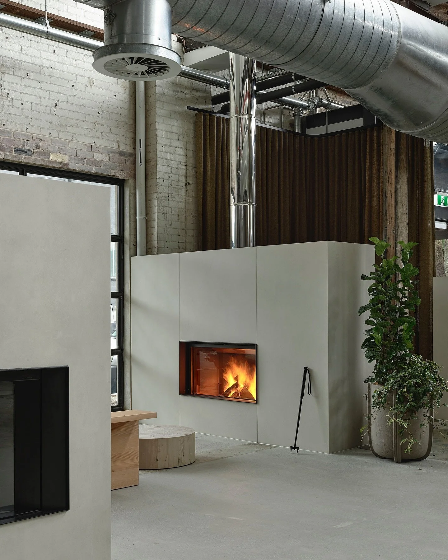 More from the Oblica Sydney showroom.
An industrial shell reworked into something quieter, more considered - where raw brick, exposed ducting and timber trusses frame a series of sculpted forms finished in Venetian plaster and microcement. Soft stone