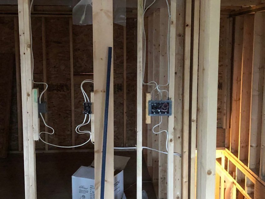 Residential electrical rough-in behind the finished walls