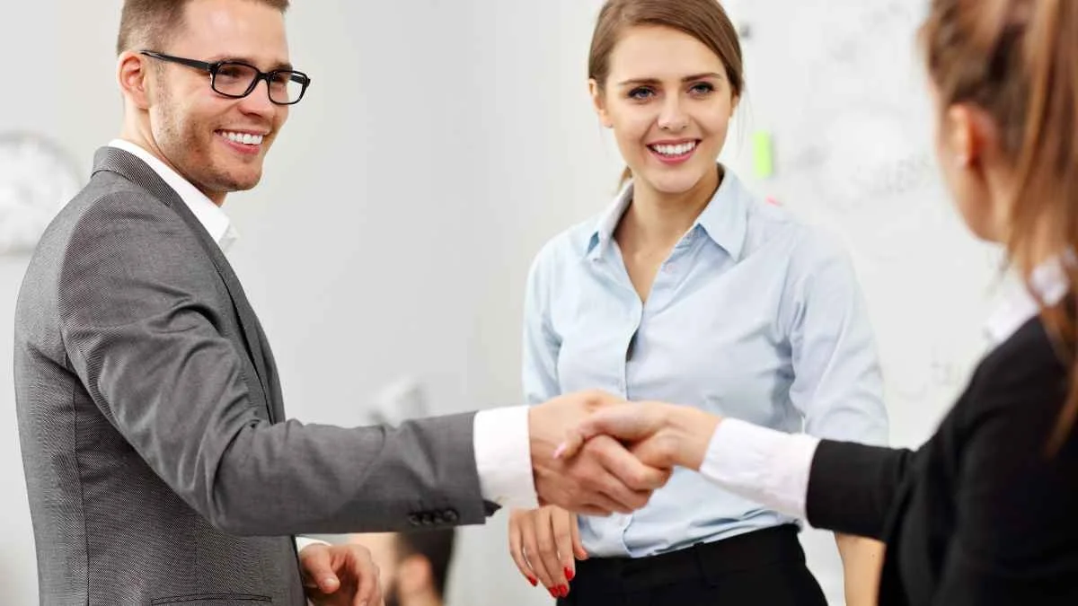 Woman introducing man to another woman