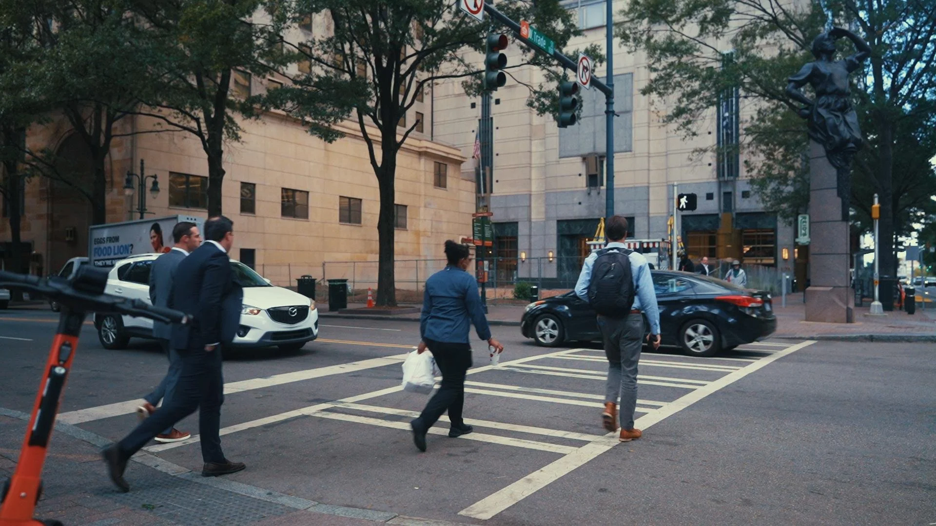 Photo of pedestrians crossing Trade and Tryon streets in Charlotte, NC, taken by a photographer with Charlotte Content Marketing.