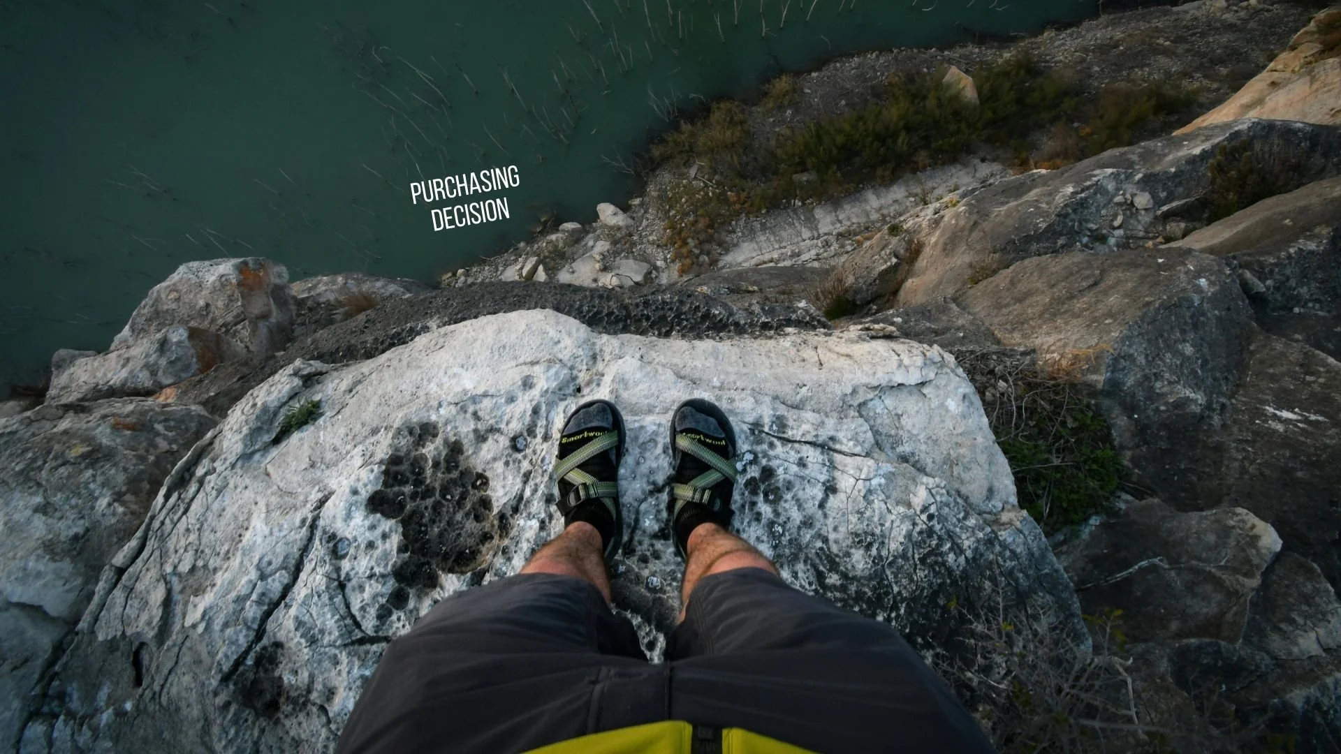 photo of a person standing on the edge of a risky cliff with text at the bottom