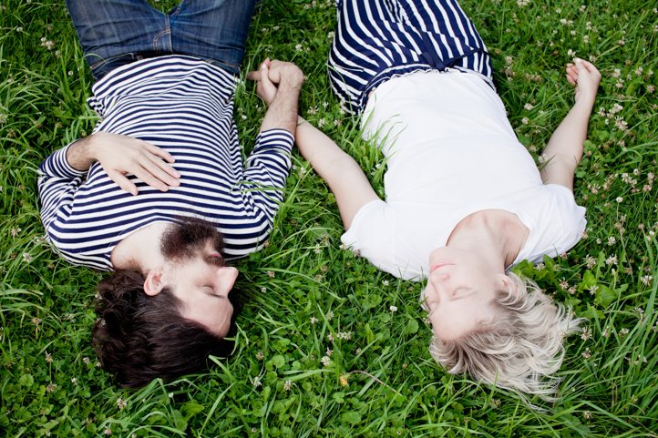 Randy &amp; Kelsey Taylor hold hands and lay in their backyard at their home in Hudson, NY