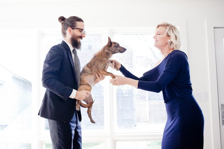 Randy &amp; Kelsey Taylor dance while holding their small dog in their home in Hudson, NY