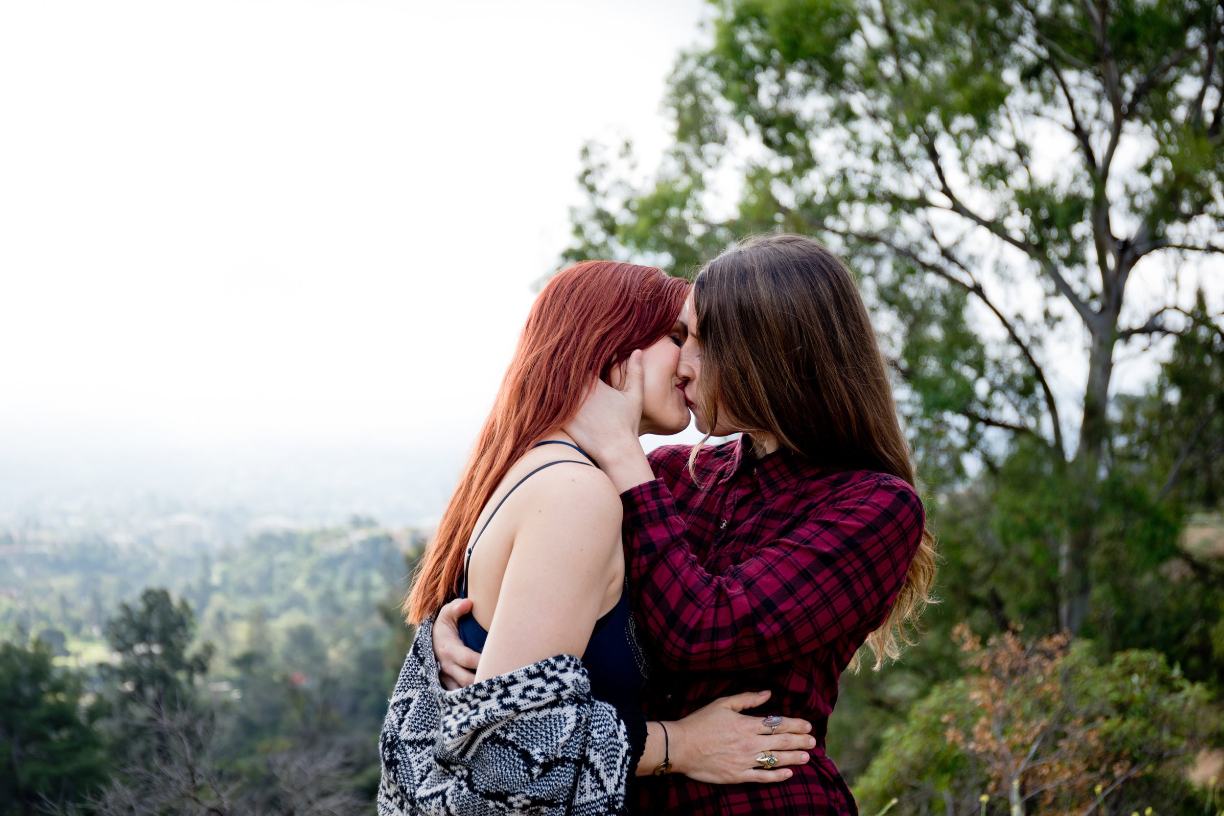 Courtney &amp; Tierney kissing with the hills of Los Angeles in the background