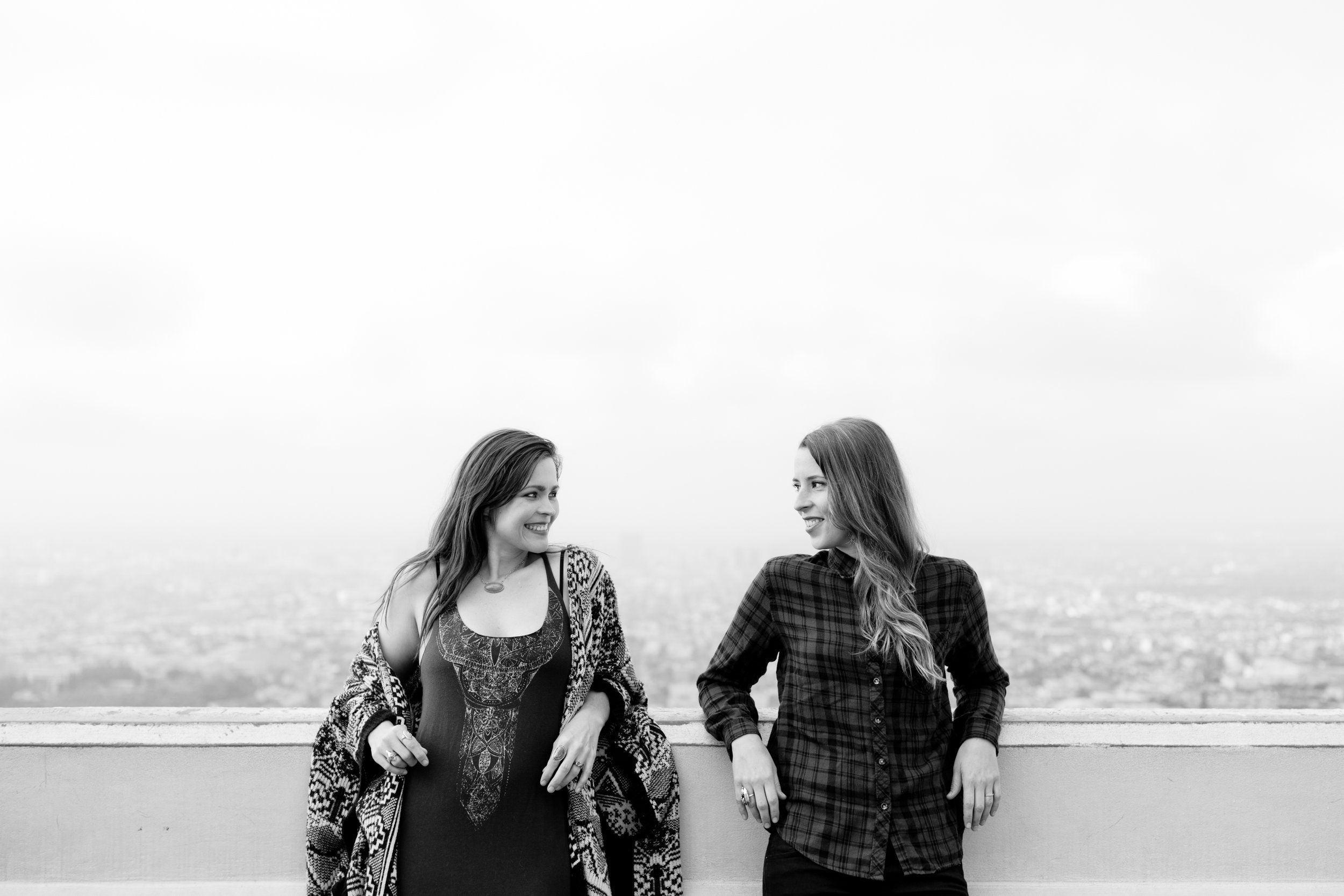 Black and White shot of Courtney &amp; Tierney looking at each other with LA in the background
