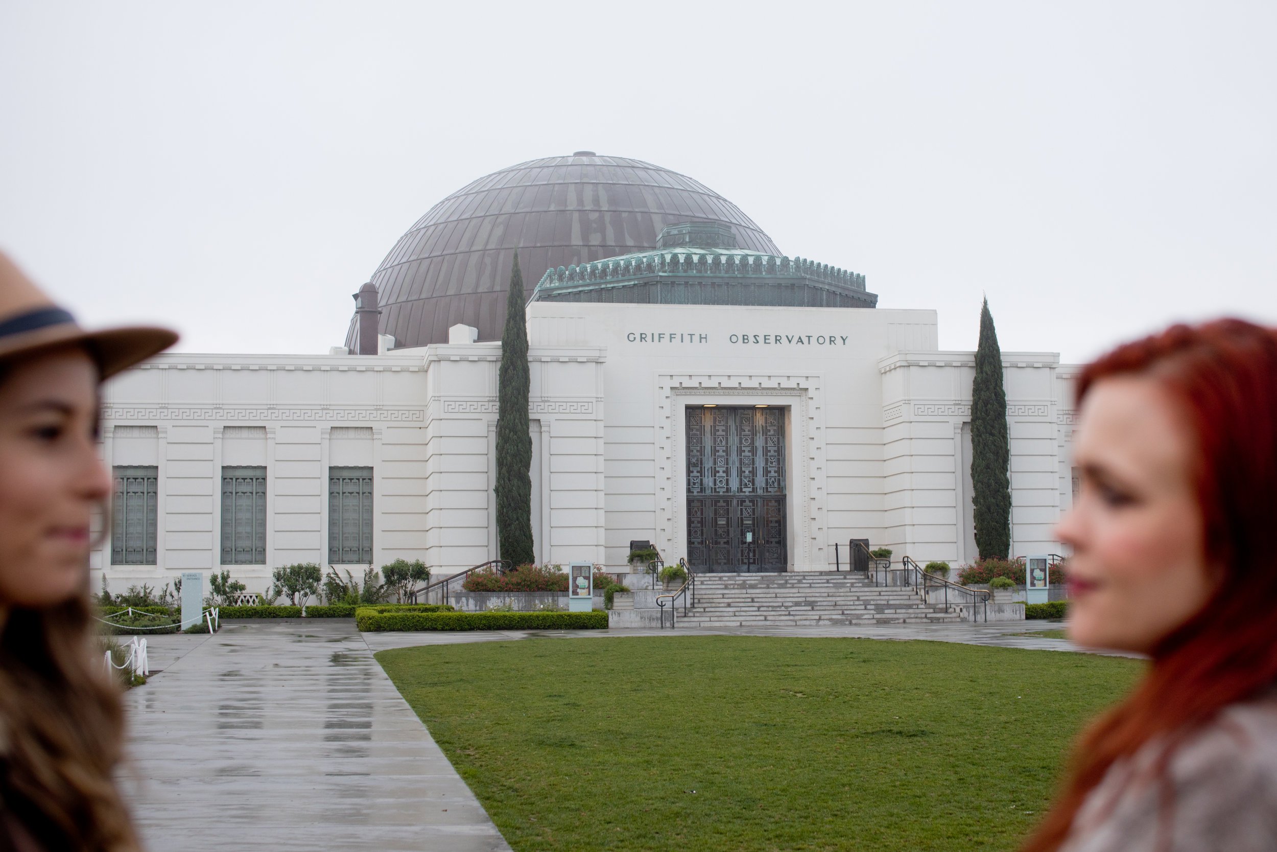 Tierney &amp; Courtney look at each other with the Griffith Observatory as the back drop in LA