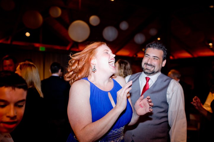 Wedding guests dancing and smiling at the reception