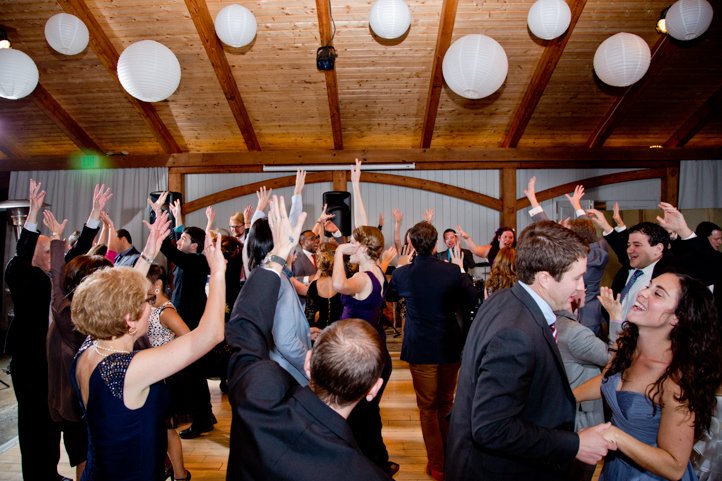 Wedding guests with their hands up, dancing
