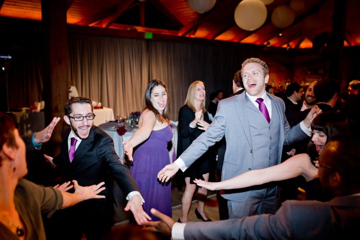 Scott and wedding guests dancing in a circle