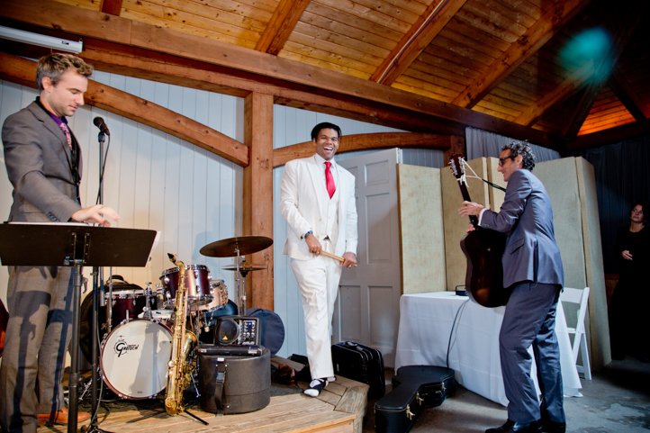 Arthur holding drumsticks on stage with the wedding band