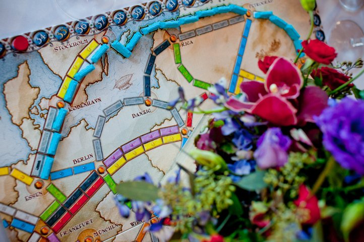 Ticket to ride board game with flowers placed on top of it