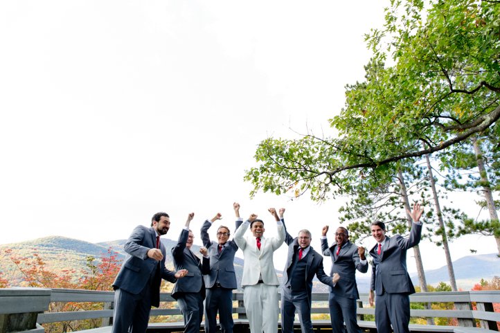 Arthur and wedding party celebrating on a deck with the Catskills in the background