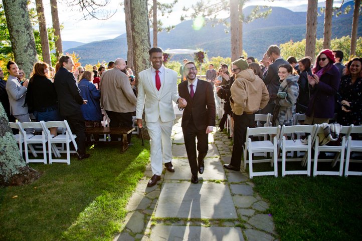 Arthur and Scott walk down the aisle together as a married couple with Hudson Valley in the background