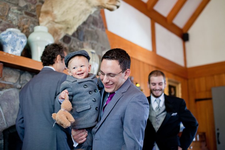 An adult and child wedding guest smile in a large cabin in Hudson Valley NY
