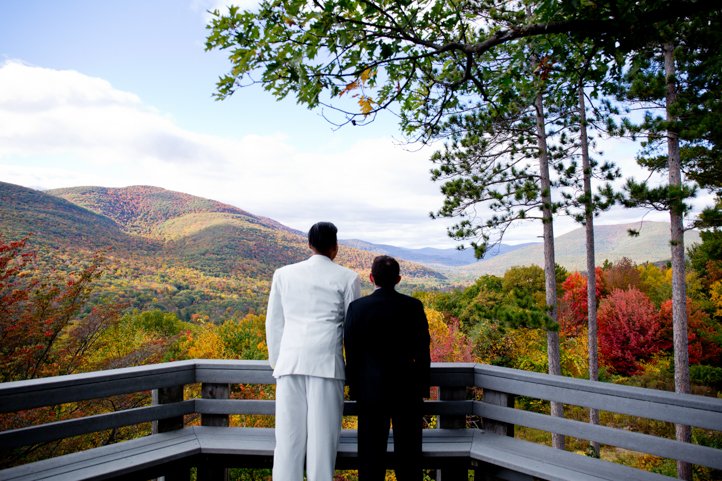 Arthur &amp; Scott stand side-by-side looking out on Hudson Valley to see rolling hills and trees turning colors