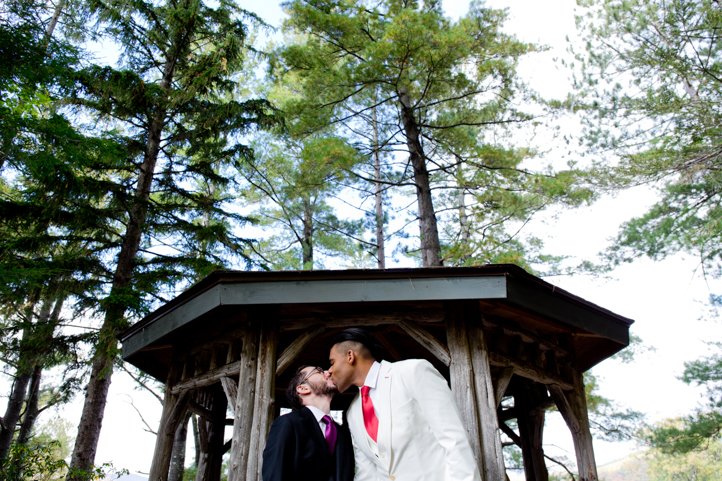 Arthur &amp; Scott kiss in front of a gazebo in the woods in Hudson Valley, NY