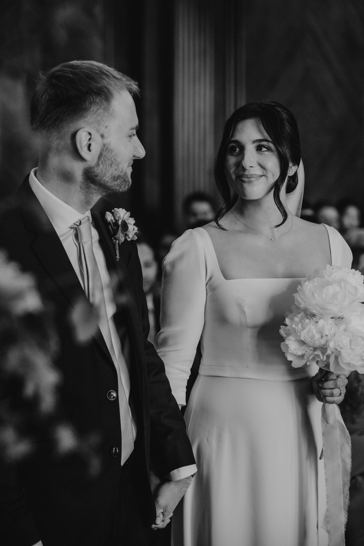 bride and groom holding hands in ceremony