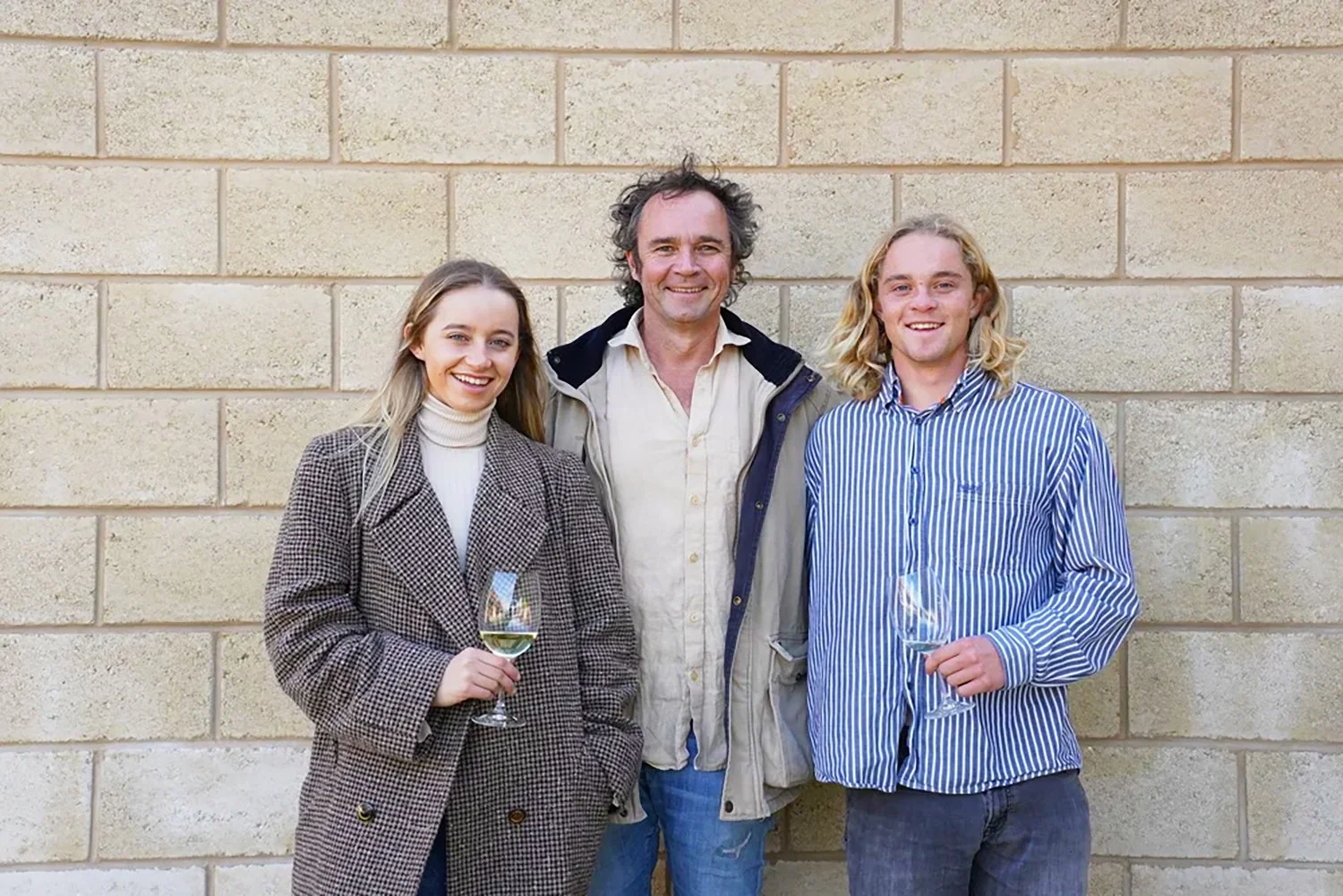 Daisy, Derek and Harry Hooper at Cape Jaffa Wines, standing with glasses in hand; second-generation family winemakers on South Australia's Limestone Coast.