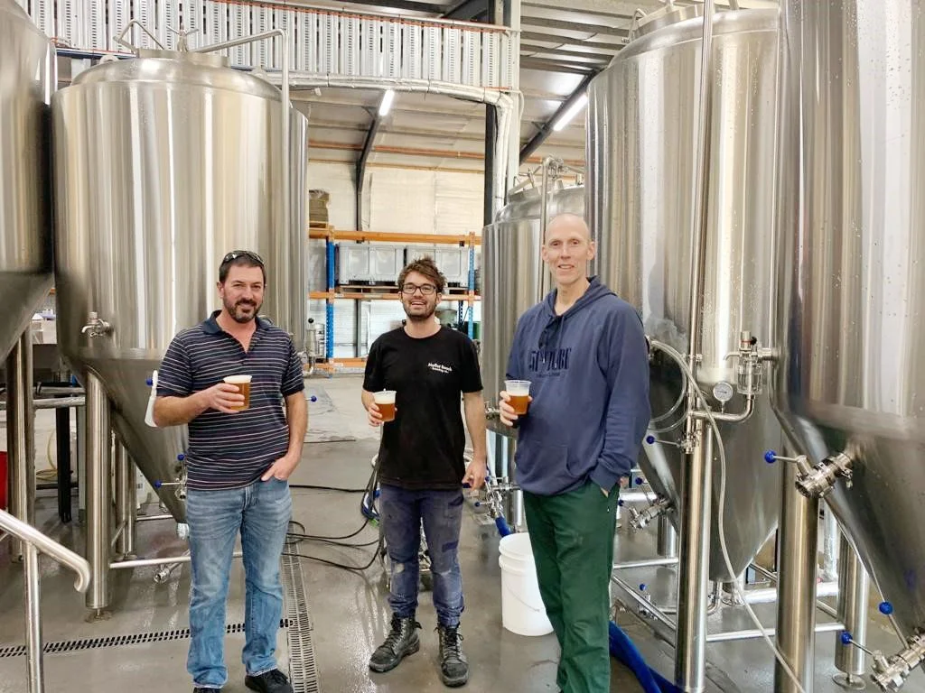 Staff from Loophole Brewing Co. standing inside the brewery with Loophole Brewing Co. customers on a brewery tour.