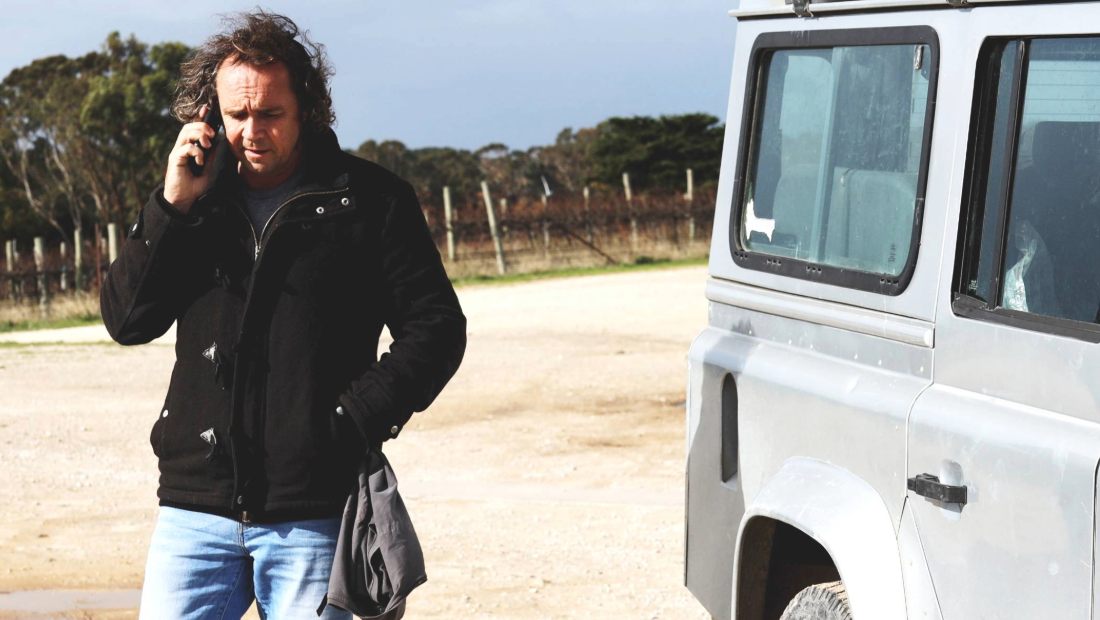 Derek Hooper from Cape Jaffa Wines talking on his mobile phone outside The Cellar Door which is located nearby Robe on the Limestone Coast in South Australia