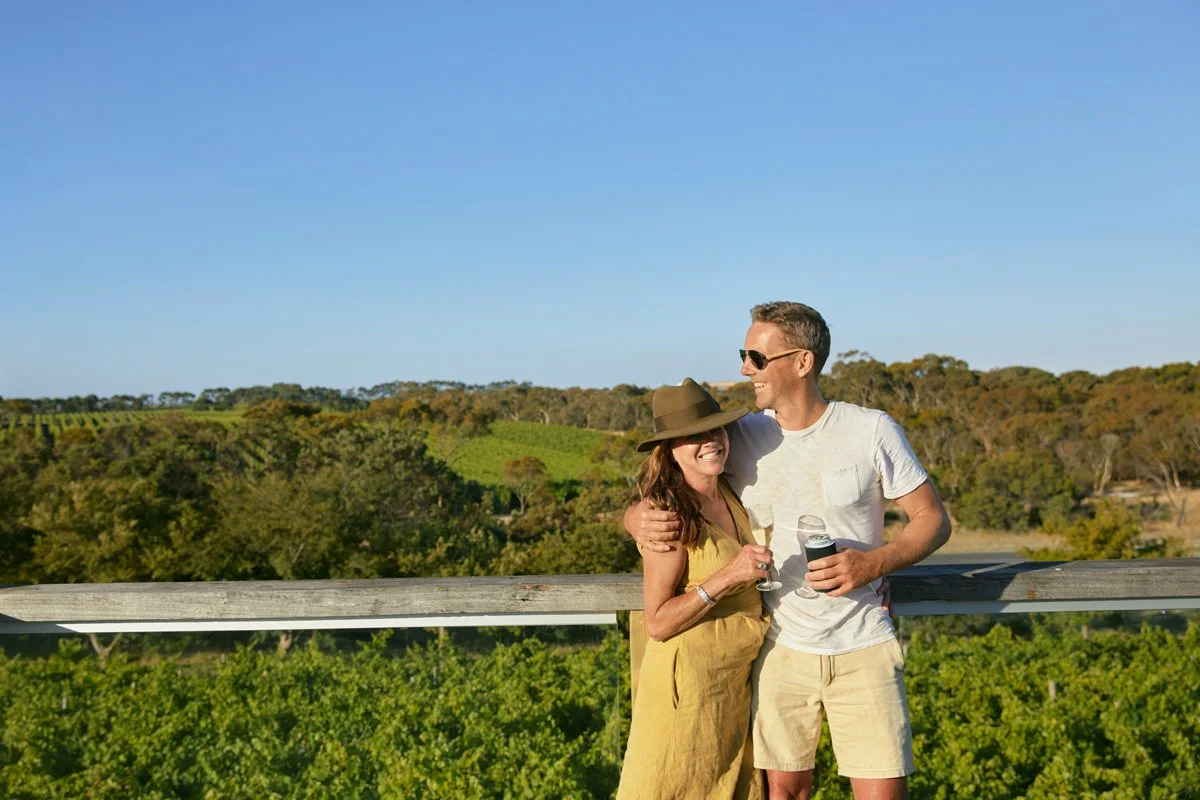Guests enjoying a cuddle on the Cellar Door outdoor deck. They're experiencing a blend of the best of craft beer and wine tastings on the Limestone Coast.