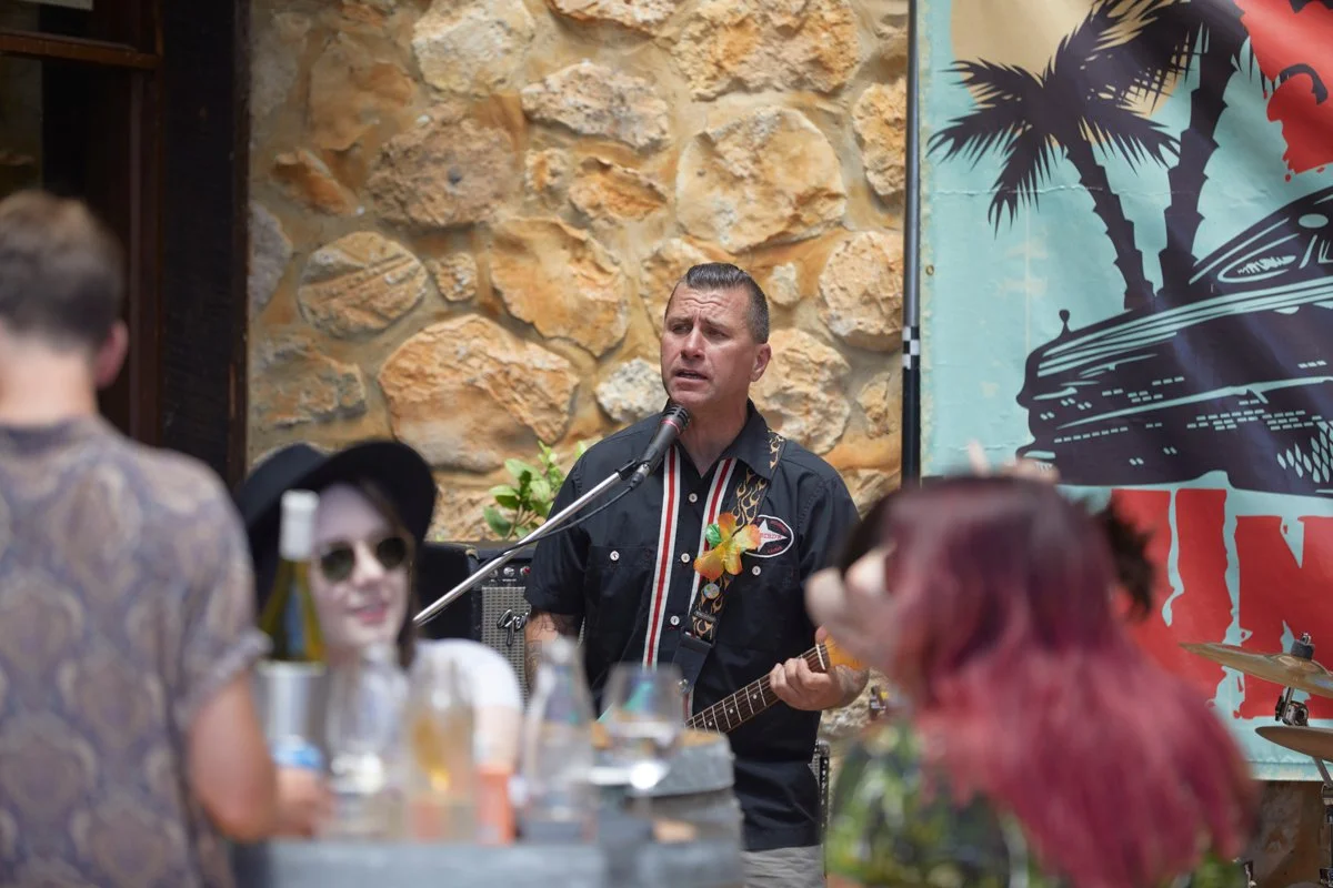 Live musician performing at Cape Jaffa Wines' cellar door courtyard — where live music, relaxed vibes, and biodynamic wine tasting meet coastal hospitality.