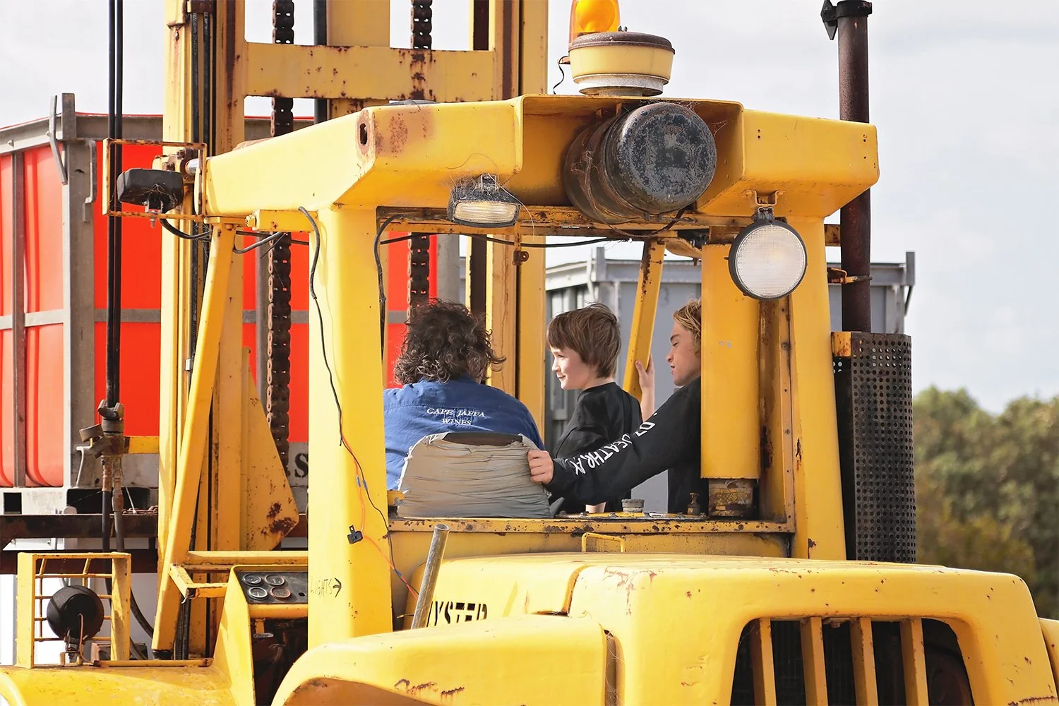 Derek, Charlie and Harry Hooper chatting on the forklift at Cape Jaffa Wines; two family generations working together during vintage on the Limestone Coast.