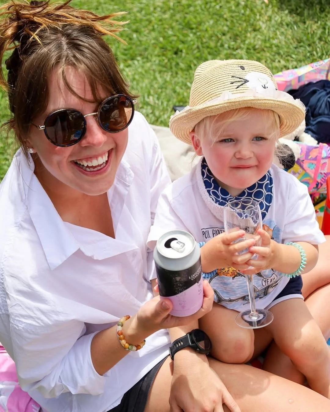 Young mum and toddler smiling during a sunny day at Cape Jaffa Wines — capturing the family-friendly, casual lawn sessions with craft beer and wine.