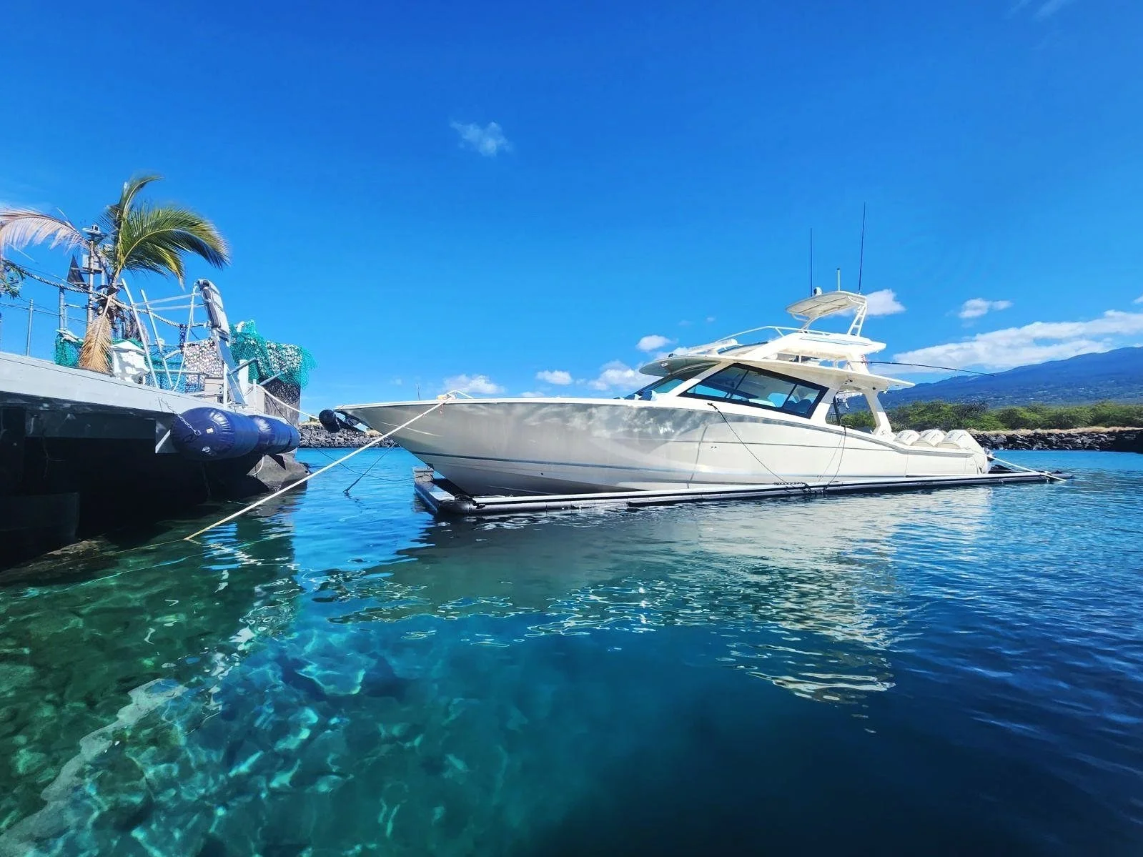53' Scout floating on the water, completely dry, in a Solstice SeaPen Dry Dock in Hawaii