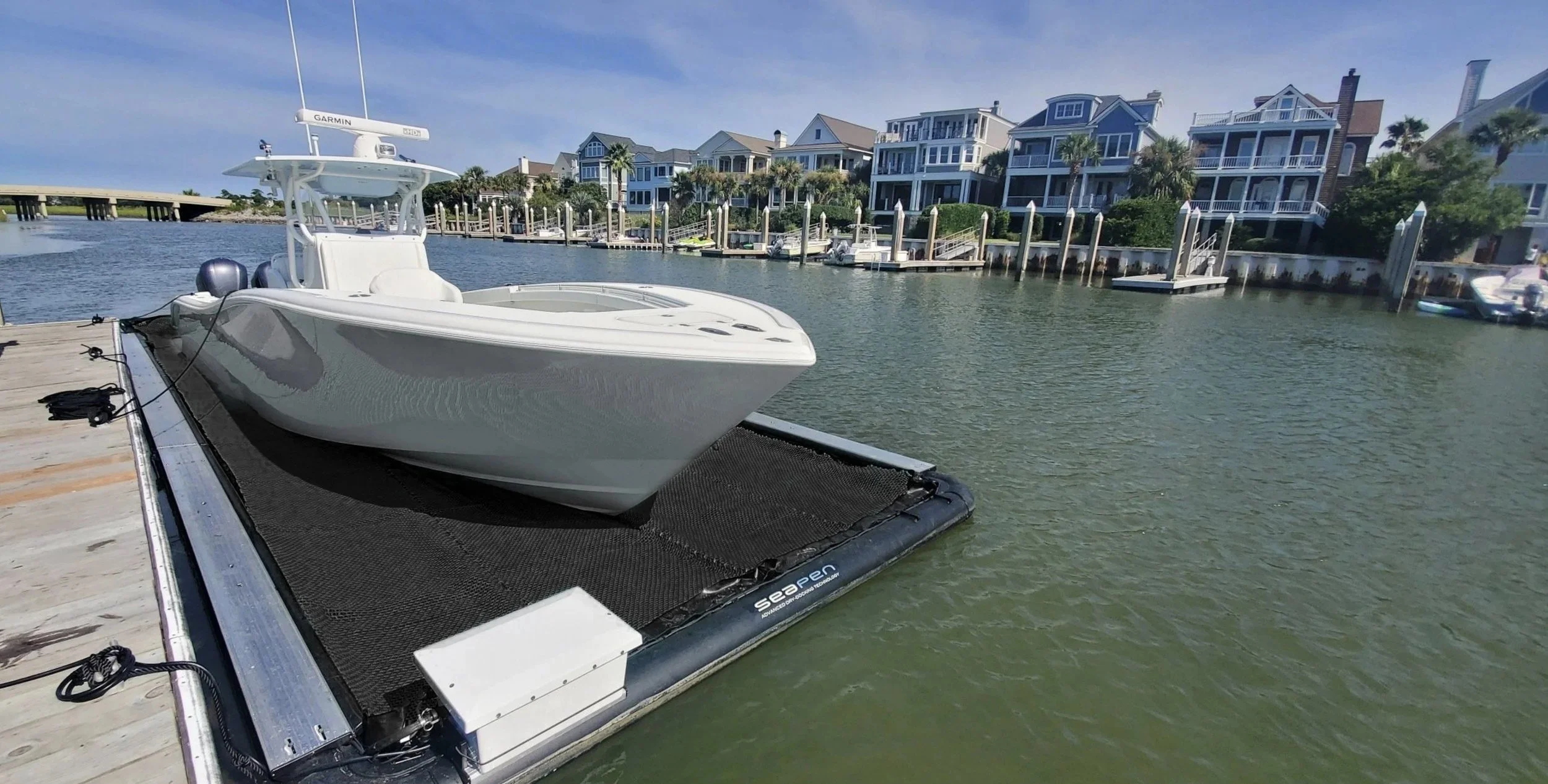 36-foot Yellowfin floating on the water, completely dry, in a Solstice SeaPen Dry Dock with no bottom paint