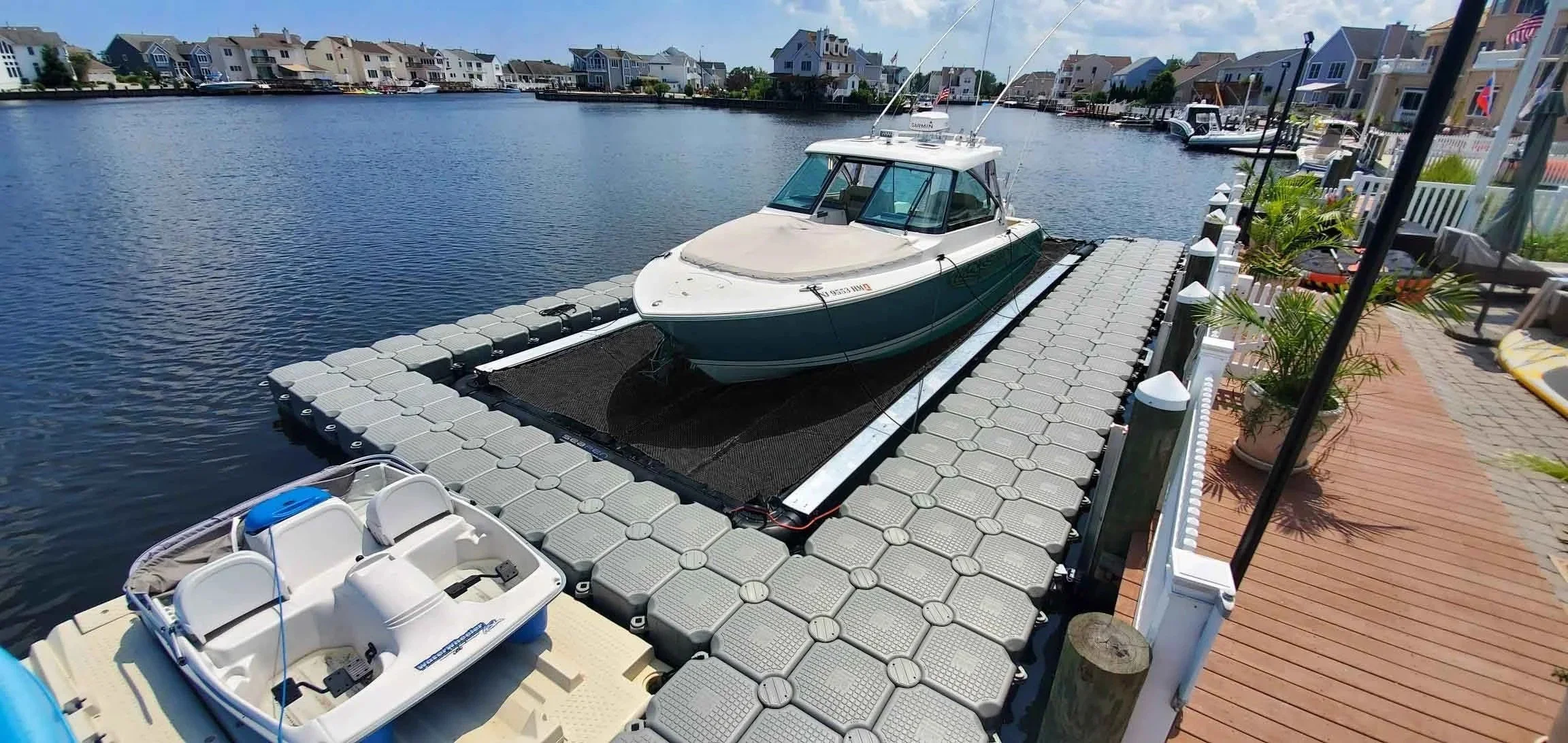 34-foot Pursuit floating on the water, completely dry, in a Solstice SeaPen Dry Dock in New Jersey
