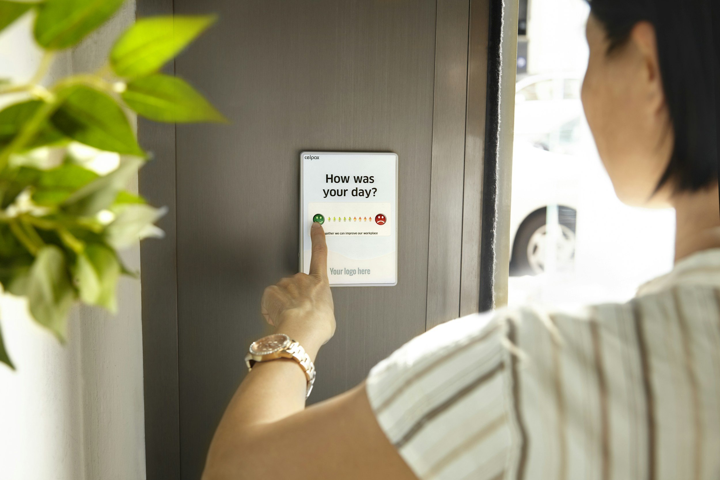 a woman holds her finger over a survey reading "How was your day?"