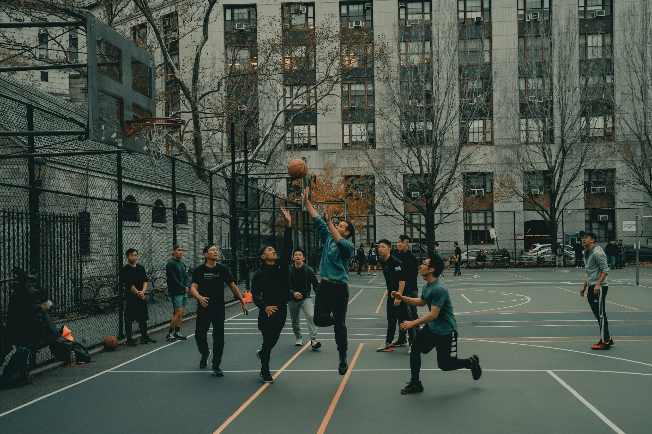 Kids playing basketball in a city